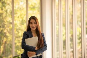 Young women are relaxing after working in an office setting with natural background photo