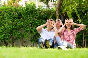 A happy young family spends time playing together in the garden at the front of house the vacation. photo