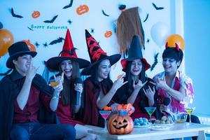 Asian young people in costumes attend celebrate at Halloween party photo