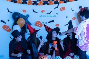 Asian young people in costumes attend celebrate at Halloween party photo