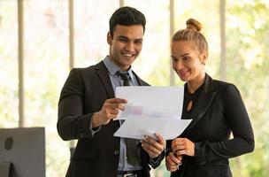 Businessmen and women analyze data and consult various issues photo