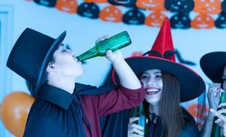 Asian young people in costumes attend celebrate at Halloween party photo