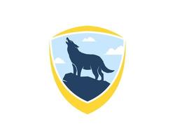 Abstract shield with howling wolf in the hill vector