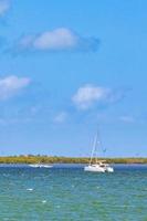 Panorama landscape view Holbox island turquoise water and boats Mexico. photo
