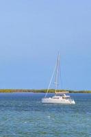 Panorama landscape view Holbox island turquoise water and boats Mexico. photo