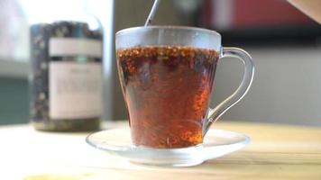 Herbal tea in a glass with a spoon stir video
