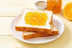 Slices of bread with orange jam photo