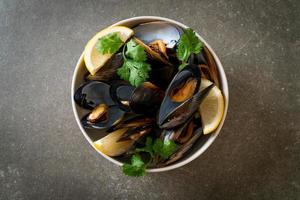 Mussels with herbs in a bowl with lemon photo