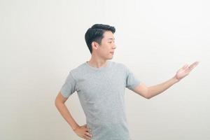 Asian man with hand pointing or presenting on white background photo