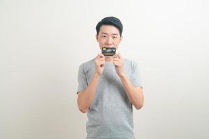 young Asian man holding credit card photo