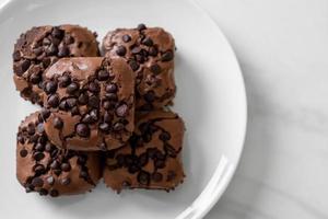 dark chocolate brownies topped by chocolate chips photo