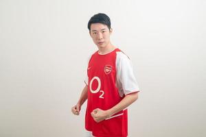 Bangkok, THAILAND - Nov 27, 2021 - Young Asian man wearing Arsenal shirt with white background. photo
