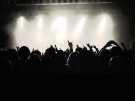 Hands silhouette in the air on concert - image photo