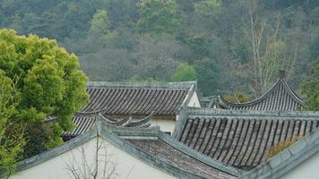 The beautiful traditional Chinese village view with the classical architecture and fresh green trees as background in spring photo