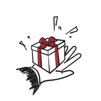 dibujado a mano doodle mano da una caja de regalo con una ilustración de lazo vector