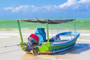 Beautiful Holbox island beach colorful old boat turquoise water Mexico. photo