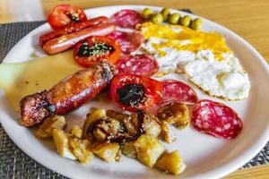 Typical english breakfast on a white plate. photo