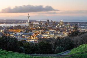Auckland city skyline with Auckland Sky Tower from Mt. Eden at sunset New Zealand