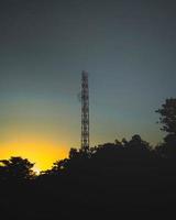 Signal network tower with blue sky background photo