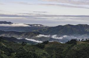 Mountains trees clouds cool weather. photo