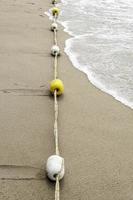 buoy yellow and white on the beach photo