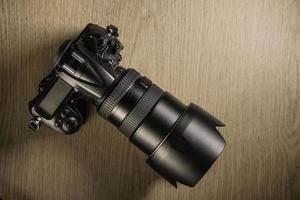 top view of retro camera on wooden table photo