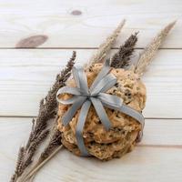 Place the cookies with a ribbon tied on a wooden floor. photo