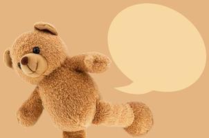 studio photo of brown light bear toy dialog