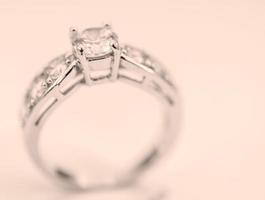 A contemporary diamond ring isolated on vintage background. photo
