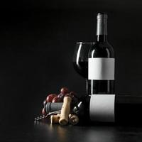 corkscrew grape near bottles wineglass