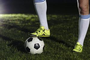 crop legs stepping soccer ball