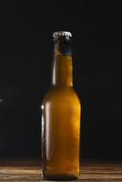 close up beer bottle wooden desk photo