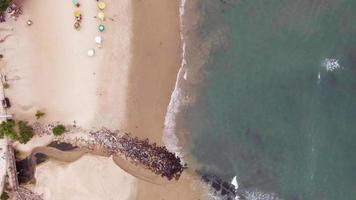 Aerial view from a drone over people playing on the beach video