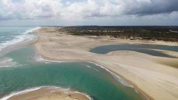 Panoramic aerial view of a deserted beach with few people video