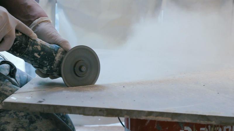Worker cutting a tile using an angle grinder at construction site 5020639 Stock Video at Vecteezy
