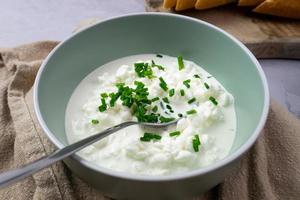 Cottage cheese with chives in a bowl. Delicious breakfast.