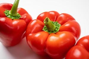 Ripe red peppers on a white background. photo