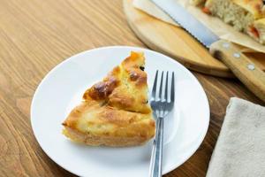 Focaccia surrounded by kitchen accessories photo