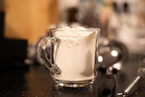 A glass filled with flour. Preparation of products for cooking. photo