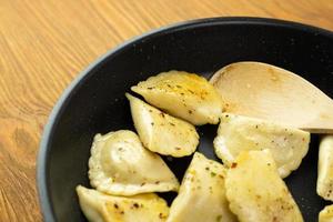 Stuffed dumplings fried in a pan. Delicious traditional dish. photo