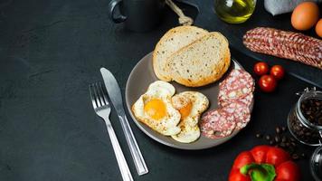 Fried egg with bread and salami photo