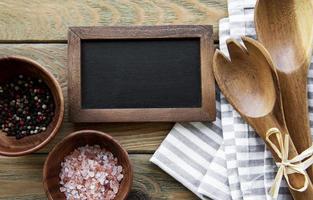 Empty chalk board and kitchen utensils photo