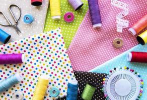 Sewing accessories and fabric. Top view, flat lay. photo