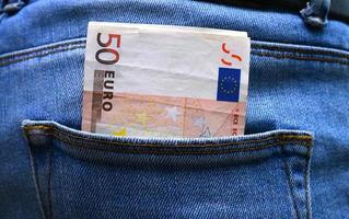 Back pocket with money blue jeans photo