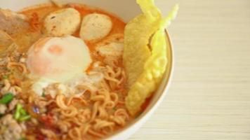 instant noodles with pork and meatballs in spicy soup or Tom Yum Noodles in Asian style video