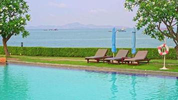 beach chair or pool bed with umbrella around swimming pool at sunset time video