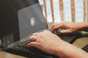 Man using computer laptop  virtual icon play video. modern Internet technology , Social Networking, online marketing, digital online.  concept technology photo