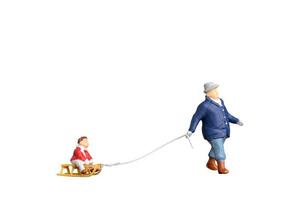 Father towing sledge with child isolated on white background with clipping path photo