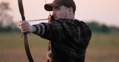 Man with bow outdoors in the field photo