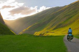 cyclist cycling in scenic mountains photo